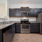Spacious kitchen with stainless steel appliances and granite countertops