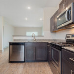 Spacious kitchen with stainless steel appliances and granite countertops