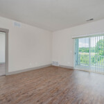Interior living space with wood vinyl flooring to private patio