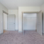 Carpeted bedroom with closet